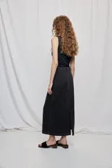 Falda larga de denim negro con diseño a rayas verticales y calce recto, tiro medio, bolsillos y cierre con botón.