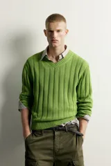 Sweater de punto canalé en hilatura de algodón, color verde, con cuello en V y manga larga.