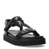 Sandalias negras de plataforma con tiras de cuero sintético y apliques metálicos.
