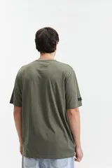 Remera de manga corta color beige, con escote redondo y fit regular. Presenta un estampado frontal en color marrón con la palabra "Resilience" en tipografía gótica y el texto "Original The World Has Changed Established Since 1976 // NLD Mistral".