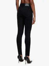 Pantalón de jean Diesel modelo Slandy-High, de corte skinny, tiro alto y calce ajustado hasta el tobillo. Confeccionado en denim superelástico color negro.