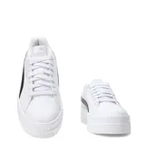 Championes de plataforma Puma modelo Karmen Classic, de color blanco con la franja lateral característica en negro y detalles dorados de la marca. Poseen suela chunky de goma y capellada sintética.