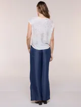 Buzo tejido de punto liviano y silueta holgada, con cuello bote cerrado, mangas cortas estilo japonesa, espalda de caída recta y ruedo curvo a la cadera. Presenta diseño estampado floral en tonos pasteles.
