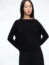 Sweater de tejido de punto color negro, con cuello redondo a la base, mangas largas y tajos laterales en el ruedo. Presenta una silueta holgada y cómoda.