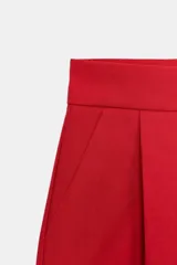 Shorts de tiro medio con bolsillos laterales y detalle de pinzas delanteras. Cierre frontal con cremallera, botón interior y gancho metálico.
