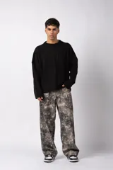 Sweater de punto color blanco con diseño de textura combinada, presentando un lado liso y otro con tejido trenzado. Posee cuello redondo, mangas largas y un corte relajado.