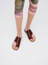 Sandalias chatas de cuero color crudo, con diseño geométrico y minimalista.