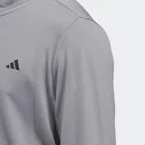 Buzo gris de golf Adidas con medio cierre frontal y logo de la marca en el pecho. Confeccionado en tejido de punto doble ligero y suave.