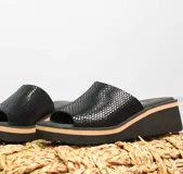 Zuecos de cuero color tostado con textura de reptil, plataforma baja y suela cómoda.