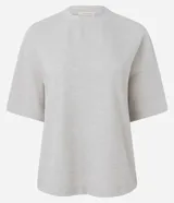 Blusa de corte oversized, color negro, con cuello redondo y mangas cortas. Confeccionada en una mezcla de poliéster y algodón.