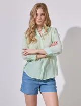 Camisa verde agua de gasa bambula, marca Cupio. Tiene cuello con solapa, abertura central con botones y largo de espalda mayor al delantero.