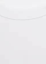 Camiseta de manga larga con cuello redondo y diseño recto, confeccionada en algodón.