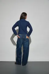 Jean de corte wide leg en color azul oscuro, con diseño de costuras laterales marcadas y tiro medio.