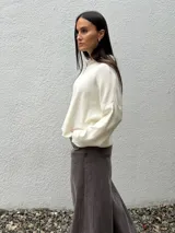 Sweater de tejido bremer color marrón, con cuello polo y cierre frontal parcial, de manga larga y diseño holgado.