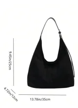 Bolso tipo hobo de material tipo gamuza o nobuk, color marrón camel. Presenta un diseño de silueta suave y caída, con una correa de hombro delgada de cuero liso del mismo tono.