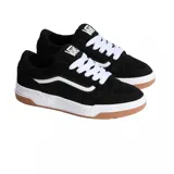 Championes Vans Hylane de estilo skate, color negro con la clásica franja lateral Sidestripe en blanco. Presentan cordones gruesos blancos, suela blanca gruesa de gran amortiguación y suela exterior de goma tipo waffle de color caramelo.
