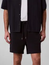 Short de tejido waffle color azul marino, con cintura elástica y cordones ajustables, de talle medio y corte relajado.