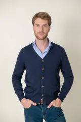 Cardigan de lana merino en color azul marino, con escote en V, cierre frontal con botones y dos bolsillos delanteros.