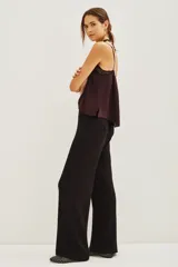 Pantalon de corte recto y tiro alto, confeccionado en tejido de viscosa y poliamida, con diseño liso y caída fluida.