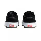 Championes Vans modelo Skate Era Wafflecup, color negro con suela blanca de plataforma y detalles en goma marrón. Presentan diseño de caña baja, cierre con cordones y costuras reforzadas.