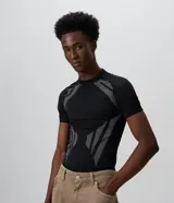 Remera masculina de poliéster seamless con corte ajustado, cuello redondo y manga corta. Presenta un diseño negro con perforaciones estratégicas y tramas geométricas en contraste en los hombros, laterales y frente.