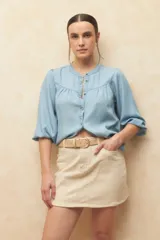 Minifalda de jean color beige claro, con corte en A y bolsillos delanteros curvos.