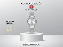 Reloj de pulsera Mini Focus modelo MF0194L con caja plateada redonda con borde de strass y dial plateado con agujas e indicadores plateados. La correa es de malla metálica plateada con cierre de gancho ajustable.