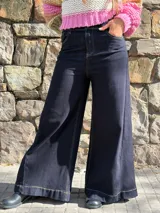 Jean azul oscuro de corte wide leg, tiro alto y diseño holgado, con costuras pespuntadas en hilo contrastante.