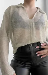 Blusa plateada traslúcida con cuello camisero y mangas largas.