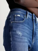 Jeans skinny de tiro alto color azul medio, con lavado gastado y roturas en las rodillas.