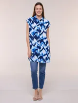 Túnica de gasa negra con estampado floral en tonos azules y blancos, cuello camisero, manga corta y cierre frontal de botones.