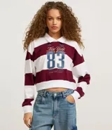 Blusa de malla de algodón con cuello de solapa y mangas largas. Tiene patrón de rayas bold y estampa delantera con lettering sportcore.