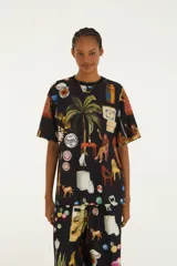 Remera negra de manga corta y cuello redondo, con estampado ilustrado de temática tropical y urbana.