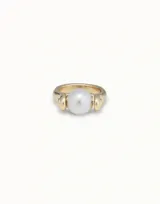 Anillo dorado con una perla blanca en el centro.