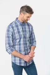 Camisa de manga larga con estampado de cuadros en tonos azules y blancos. Presenta cuello abotonado, bolsillo frontal en el pecho con logo bordado y cierre frontal con botones personalizados.