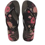 Sandalias tipo ojotas Havaianas con diseño floral en tonos rosados y dorados sobre base negra. Presentan tiras finas de color negro con textura.
