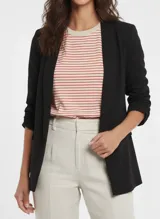 Blazer negro de corte regular con cuello solapa y bolsillos frontales.