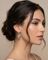 Aros colgantes con diseño de corazón plateado y argolla dorada.
