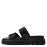 Sandalias tipo slide de color negro con plataforma dentada. Presentan dos tiras anchas superiores con hebillas metálicas ajustables y apliques de tachas plateadas.