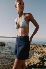 Shorts de denim azul oscuro con tiro alto, calce mom fit y diseño de cinco bolsillos con costuras en contraste.