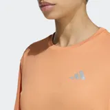 Remera deportiva Adidas de manga corta, color naranja, con cuello redondo y logo reflectivo en el pecho. Confeccionada con tecnología Climacool para absorción de sudor y diseño ergonómico para mayor libertad de movimiento.