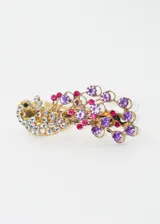Broche para el pelo dorado con forma de cisne, decorado con strass blancos, violetas y fucsias.