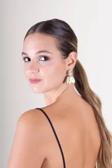 Aros colgantes dorados con dos piedras blancas circulares en la parte superior y pétalos dorados en la parte inferior.