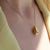 Collar dorado con dije en forma de lágrima dorada maciza.