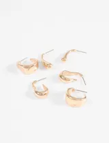 Set de tres pares de aros de diseño minimalista en color plateado, con formas orgánicas y curvas variadas.