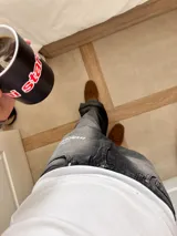 Pantalón de jean gris oscuro con corte amplio y estampado con el logo de la marca en la pierna izquierda.