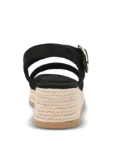 Sandalias de plataforma tipo espadrille con capellada de material sintético negro, tira ajustable al tobillo con hebilla metálica dorada y suela de yute con base de goma.
