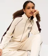 Campera deportiva de cuello alto con cierre frontal y bolsillos tipo canguro, en color beige con detalles marrones en las mangas y estampa localizada con texto "Phoenix Arizona".