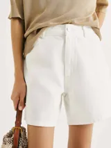 Short de jean de tiro alto en color blanco, con cierre frontal de botón y cremallera, y bolsillos laterales.