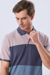 Remera polo de piqué con diseño de franjas horizontales en bloques de color, manga corta, cuello camisero y cartera de botones.
